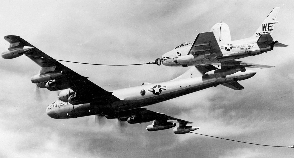 A U.S. Marine Corps North American FJ-4B Fury aircraft (BuNo 143636) of Marine Attack Squadron VMA-214 Black Sheep pulls up to be refueled by a U.S. Air Force Boeing KB-50J Superfortress.